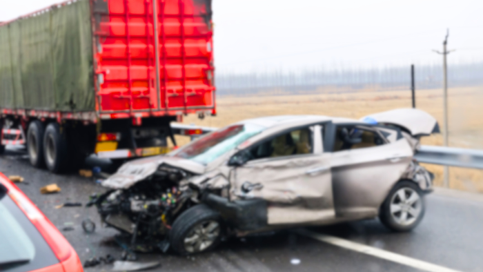 a-car-is-seen-after-a-bad-truck-accident A car is seen after a bad truck accident. A Truck Accident Injury Lawyer can help with these types of accidents.