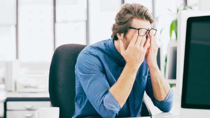 car-accident-lawyer-missouri-frustrated-person A man sits at his computer and is frustrated