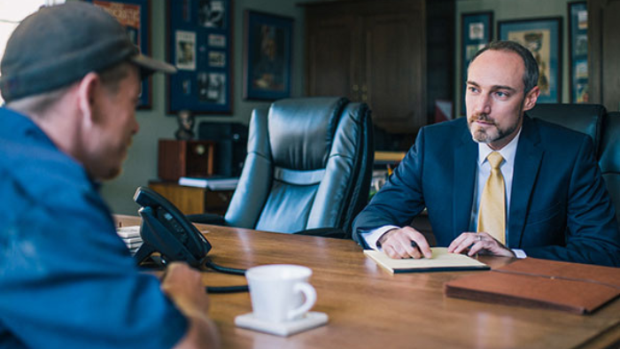 Ben Nelson, Workers' Compensation Lawyer in Columbia, Missouri Ben Nelson, Workers' Comp, Hurt at Work Lawyer, meets with a client to review his case