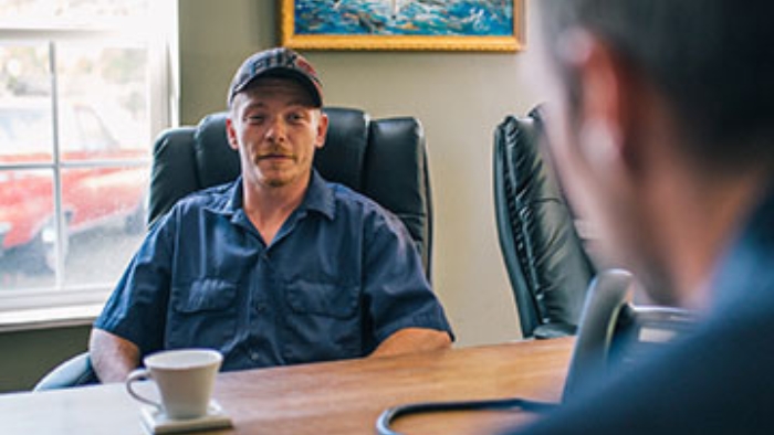 Client in office Ben Nelson, truck accident claim lawyer, speaks with a client in his office